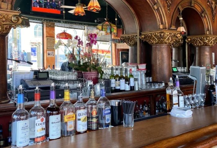 Twin Peaks Tavern bar in San Francisco, a popular gay bar. Bottles of liquor line the bar top in this cozy, historic San Francisco establishment.
