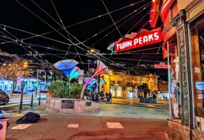 Twin Peaks Tavern in San Francisco at night. A landmark gay bar in the Castro District. Neon sign, street scene, and colorful lights.