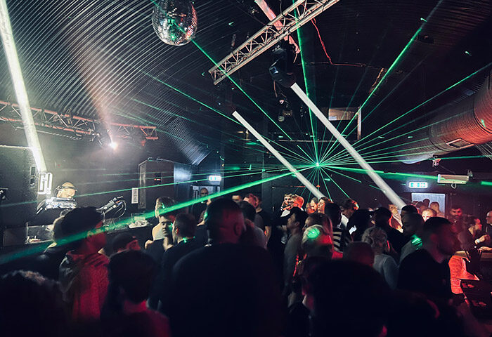 UNION Club Vauxhall: Late-night gay dance club in London. Crowd enjoying the music under disco ball and laser lights. Gay nightlife.