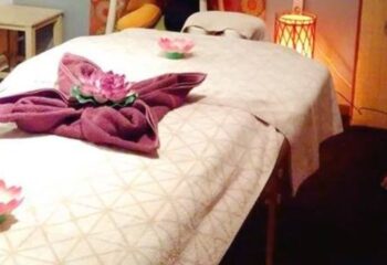 Massage table ready at Under Pressure Massage Barcelona. Gay massage in Barcelona for relaxation and wellness. Towel art with lotus flower.