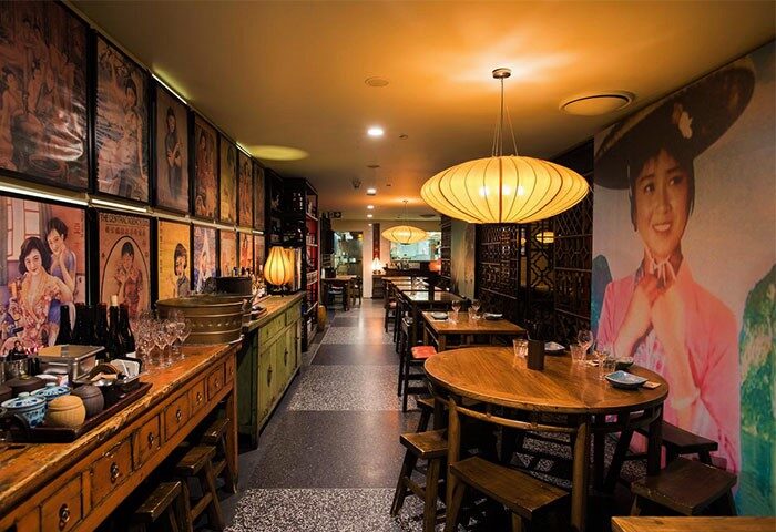 Kirketon Hotel Sydney's unique restaurant. Gay-friendly hotel with great reviews. Interior with Asian-inspired decor, warm lighting, and vintage posters.