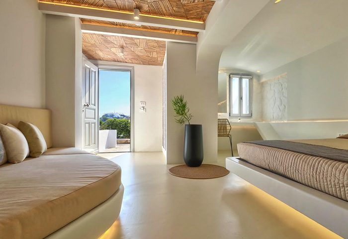 Andronikos Hotel, Mykonos: Unique design in a gay-friendly hotel. Room with a bed, couch, and view to Mykonos Town. Modern, stylish travel.