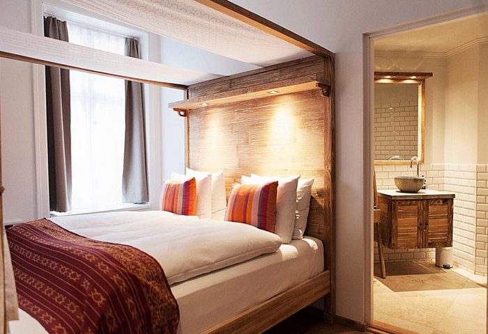 Axel Guldsmeden's unique design room. Popular gay hotel in Copenhagen near gay bars. View of bed and bathroom, for gay travel advice.