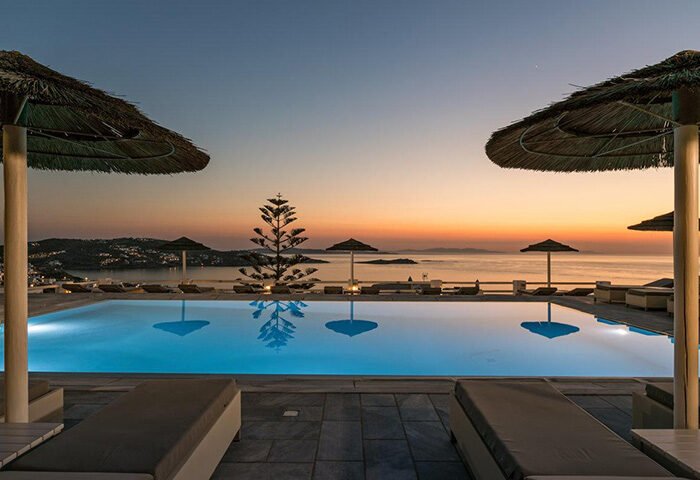 Hotel Alkyon pool view in Mykonos Town. Honeymoon destination for gay couples. Sunset over the Aegean Sea. Luxury travel ideas.