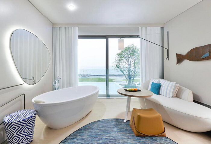 Veranda Resort Pattaya MGallery villa interior. Bathtub, daybed, and ocean view. Ideal for gay couples' honeymoon or romantic getaway.