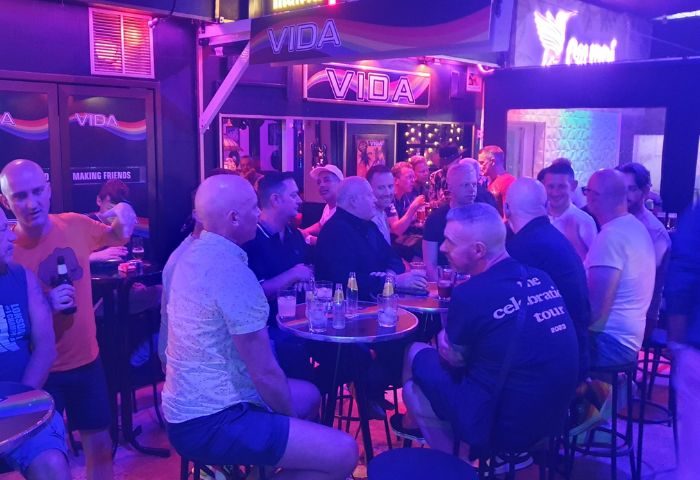 Vida Bar, a popular gay bar in Torremolinos. Men are socializing, enjoying drinks. Nightlife scene. Gay travel destination.