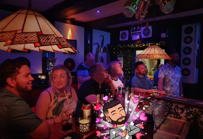 Vida Bar, a lively gay bar in Torremolinos, Spain. People are enjoying drinks and the atmosphere. Gay travel destination for men.