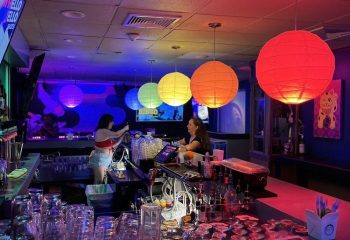 Wang Chung's Karaoke Bar in Honolulu. Bartenders, drinks, & colorful lanterns. A popular gay bar for karaoke & drag shows.