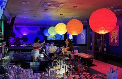 Wang Chung's Karaoke Bar in Honolulu. Bartenders, drinks, & colorful lanterns. A popular gay bar for karaoke & drag shows.