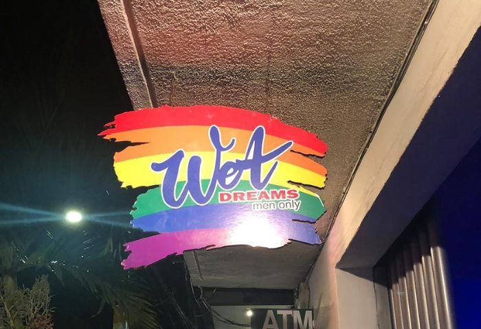 Wet Dreams gay bar sign in Puerto Vallarta. Rainbow colors. Men only. Gay travel advice. Gay nightlife.