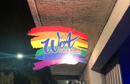 Wet Dreams gay bar sign in Puerto Vallarta. Rainbow colors. Men only. Gay travel advice. Gay nightlife.