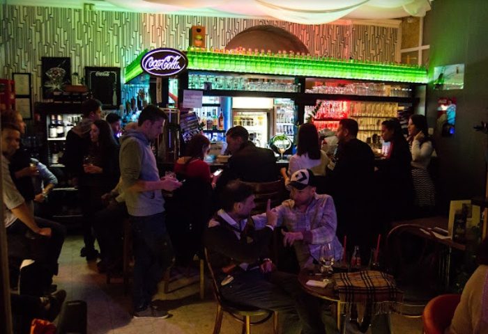 Why Not Cafe and Bar, Budapest. Gay bar scene with patrons at the bar and tables. Budapest travel advice for gay men.