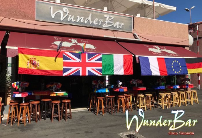 WunderBar Gay Bar in Gran Canaria. Flags of various countries hang above stools outside the gay-friendly WunderBar in Gran Canaria.