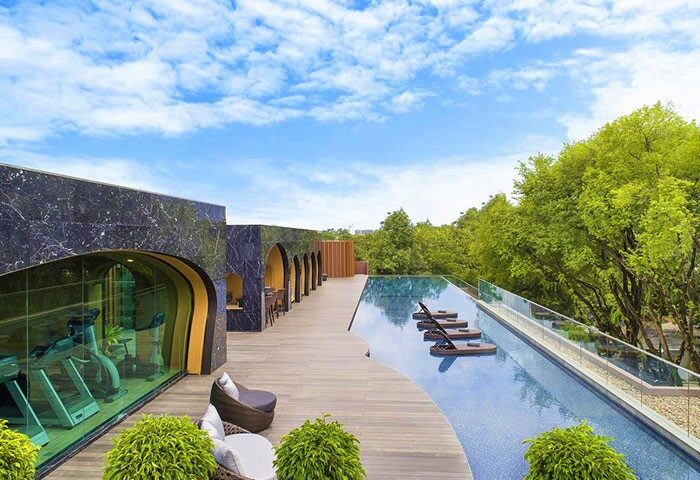 X2 Chiang Mai Riverside gay hotel's infinity pool and gym. Instagram-perfect travel destination with luxury amenities for gay men. Thailand hotel.