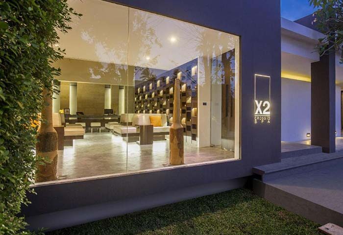 X2 Samui Spa retreat entrance at dusk. Modern design, sleek lines, and inviting ambiance. A luxurious spa experience for gay men travelers.