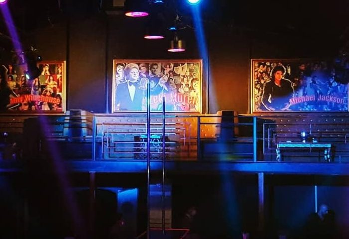 X Large Club Istanbul stage with Amy Winehouse, Zeki Müren, and Michael Jackson portraits. Gay travel advice for Istanbul nightlife.