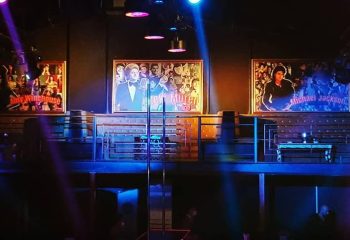 X Large Club Istanbul stage with Amy Winehouse, Zeki Müren, and Michael Jackson portraits. Gay travel advice for Istanbul nightlife.