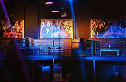 X Large Club Istanbul stage with Amy Winehouse, Zeki Müren, and Michael Jackson portraits. Gay travel advice for Istanbul nightlife.
