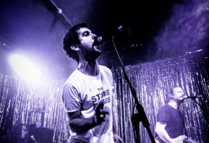 Yah Yah's Melbourne: Singer at gay-friendly bar, bathed in purple light. Live music venue with band performing, part of Melbourne's gay scene.