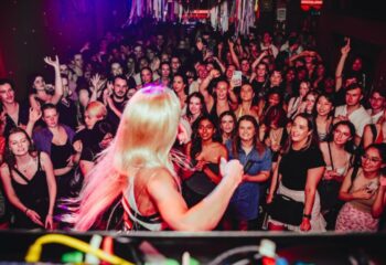 Yah Yah's Melbourne crowd, DJ's view. Nightlife scene with diverse group, enjoying music. Gay travel advice for Melbourne's vibrant bars.