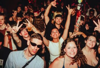 Yah Yah's Melbourne: Crowd of smiling people at a gay-friendly nightclub. Partygoers pose, making peace signs at this popular gay venue.