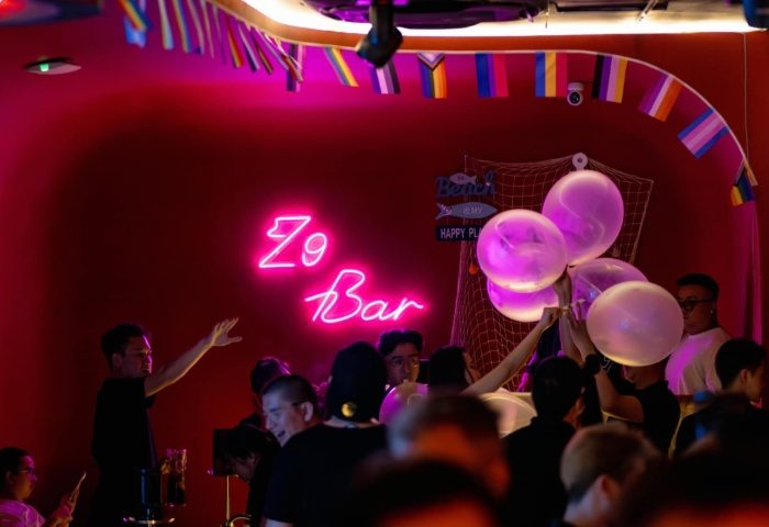 Gay nightlife in Ho Chi Minh City: Z9 Bar interior with neon sign, balloons, and a crowd of people. A popular gay bar in Vietnam.
