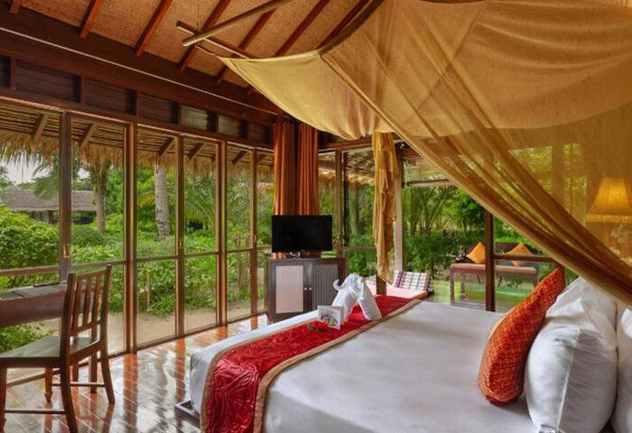 Zeavola Hotel, Koh Phi Phi. Luxury beachfront room at this gay-friendly hotel. View of the tropical garden from the bed. Thailand getaway.