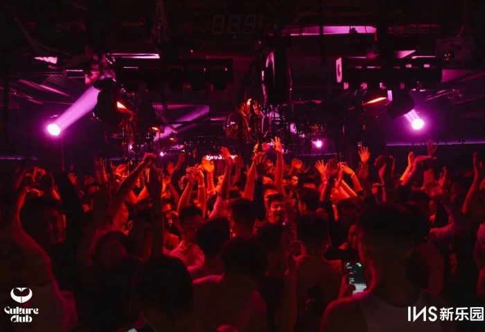 Crowd at Culture Club, a gay club. People dancing with hands up, lit by pink lights. Gay travel advice. eff12eaa-0d84-4e21-8ea9-2afe53c38b53.jpg