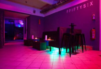 F56 Vienna: Interior of FFIFTYSIX gay bar in Vienna, Austria. Lounge area with purple and blue lighting. Gay travel advice.