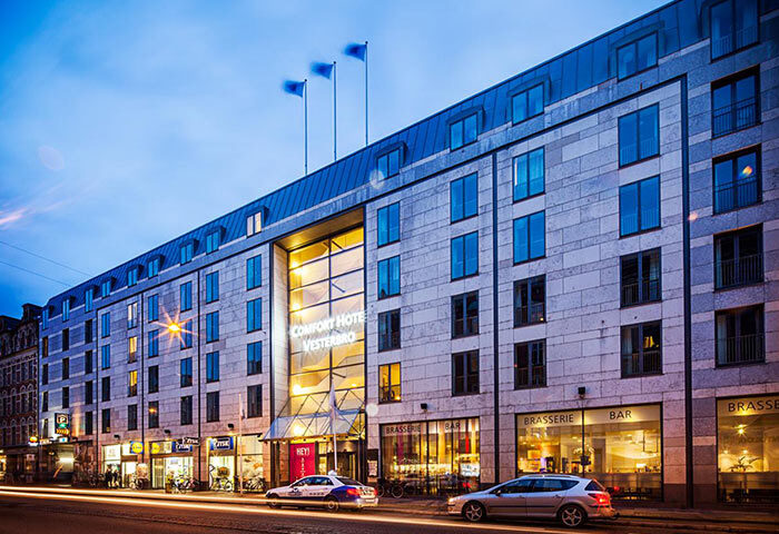 Comfort Hotel Vesterbro, a gay-popular hotel in Copenhagen's gayborhood. Exterior view at dusk, showing the hotel's facade and street scene.