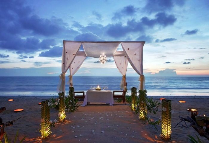Romantic private beach dining at JW Marriott Khao Lak Resort & Spa. Sunset dinner for two on the sand. Gay travel luxury experience.