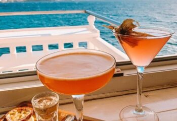 Cocktails at Katerina's Bar & Restaurant. Refreshments with ocean view, perfect for gay men travel. Enjoy drinks at a gay-friendly bar.