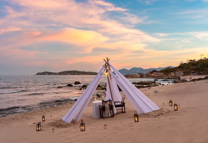 Romantic beach dinner setup at SAii Koh Samui Villas. Tent with lanterns on sand. Perfect for gay men's travel advice. mice-001318.jpg