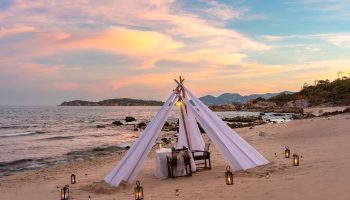Romantic beach dinner setup at SAii Koh Samui Villas. Tent with lanterns on sand. Perfect for gay men's travel advice. mice-001318.jpg