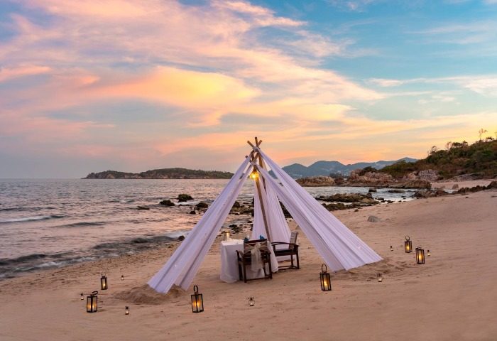 Romantic beach dinner setup at SAii Koh Samui Villas. Tent with lanterns on sand. Perfect for gay men's travel advice. mice-001318.jpg