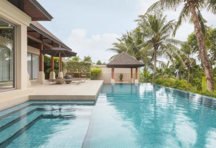 The Pavilions Phuket villa with pool. Luxury gay travel in Thailand. Tropical trees surround the resort.